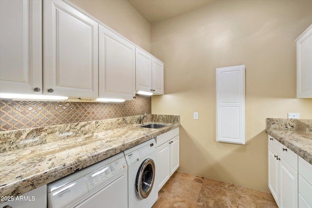 washroom with separate washer and dryer, a sink, and cabinet space
