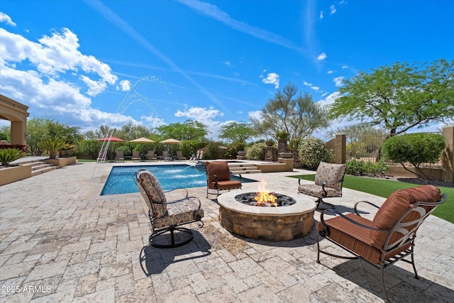 pool featuring a patio and a fire pit