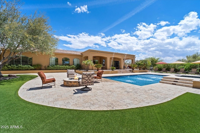 pool featuring a lawn, a patio, and a fire pit