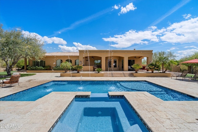 view of swimming pool with a patio, a ceiling fan, and a pool with connected hot tub