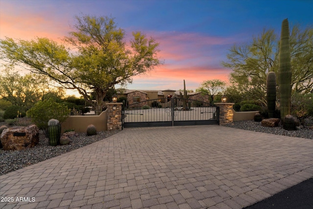 view of gate with a fenced front yard