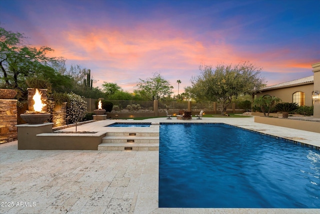 view of swimming pool featuring a patio, an in ground hot tub, a fenced in pool, and fence