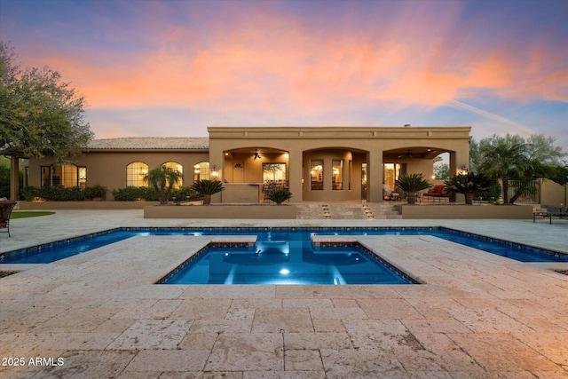 outdoor pool with a patio and a ceiling fan