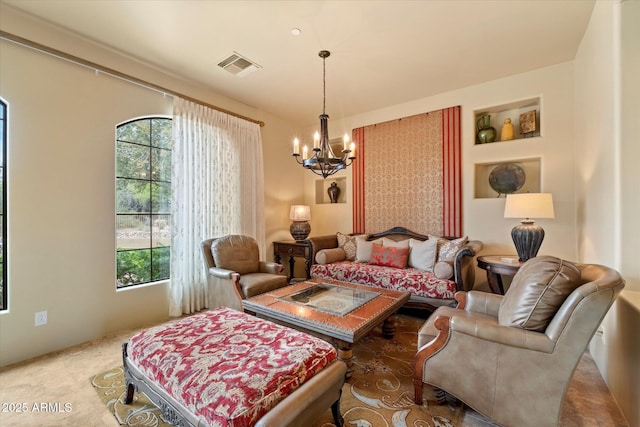 living room with an inviting chandelier, a healthy amount of sunlight, and visible vents