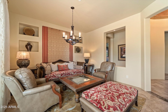 living area with arched walkways and a notable chandelier