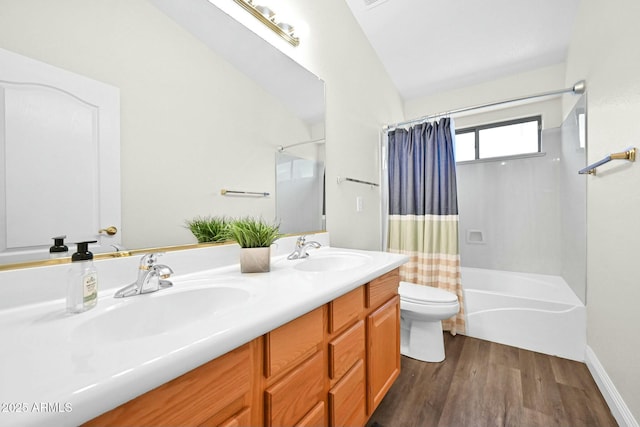 full bath with a sink, toilet, wood finished floors, and shower / bath combo