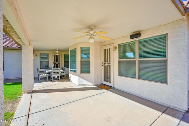 view of patio with outdoor dining space and ceiling fan