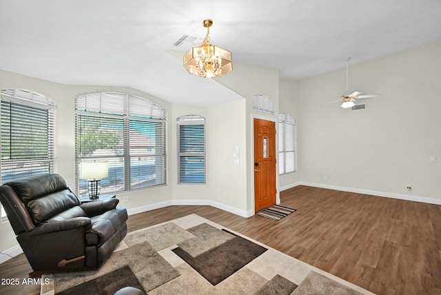 interior space with vaulted ceiling, wood finished floors, baseboards, and a wealth of natural light