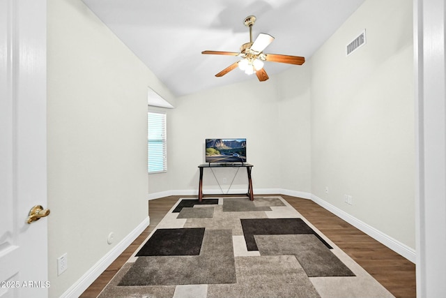 interior space with dark wood-style floors, visible vents, baseboards, and lofted ceiling