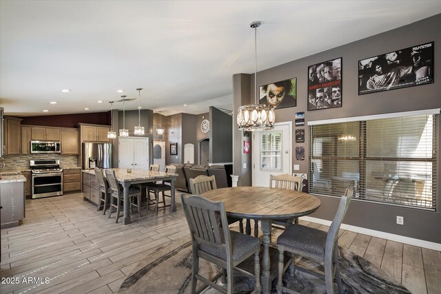 7925 E Osage Ave, Mesa, AZ 85212 - dining area with a chandelier, light wood finished floors, lofted ceiling, baseboards, and recessed lighting