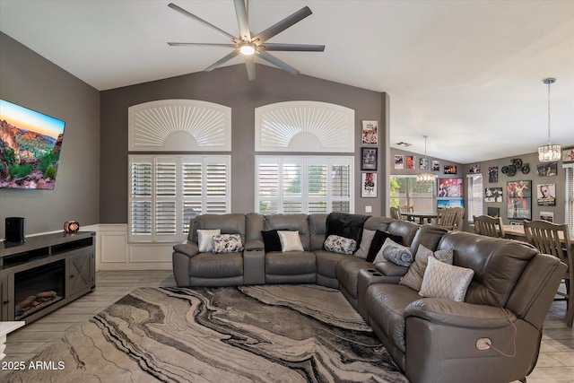 7925 E Osage Ave, Mesa, AZ 85212 - living area with vaulted ceiling, a ceiling fan, a chandelier, and a wainscoted wall