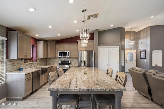 7925 E Osage Ave, Mesa, AZ 85212 - kitchen featuring stainless steel appliances, a sink, tasteful backsplash, wood finish floors, and lofted ceiling