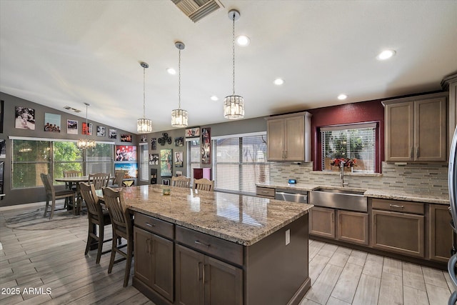 7925 E Osage Ave, Mesa, AZ 85212 - kitchen with a sink, a chandelier, vaulted ceiling, a center island, and light wood finished floors