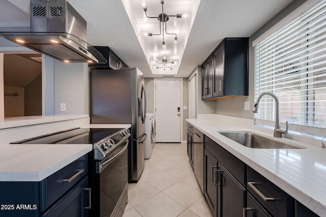 kitchen featuring sink, light stone counters, island range hood, stainless steel range with electric cooktop, and a raised ceiling