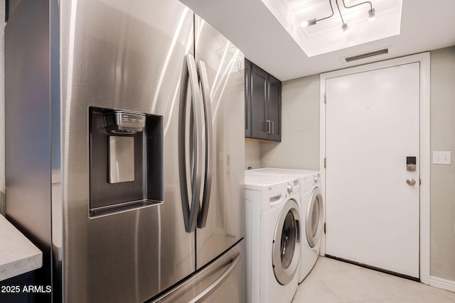 laundry room featuring cabinets and washing machine and clothes dryer