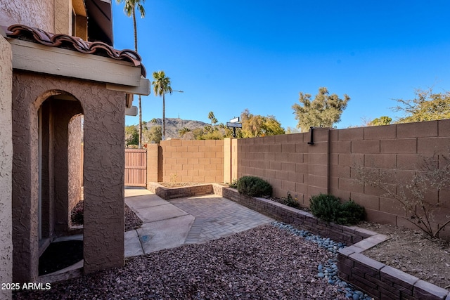 view of yard with a mountain view and a patio