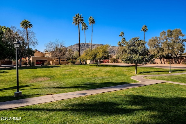 view of home's community featuring a mountain view and a lawn