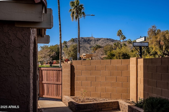 view of gate with a mountain view