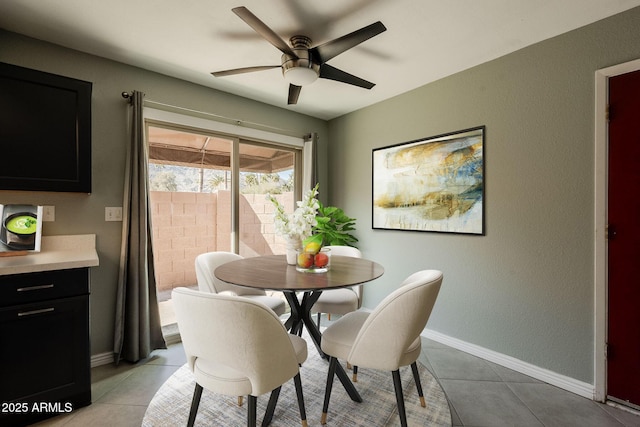 dining room with light tile patterned floors and ceiling fan