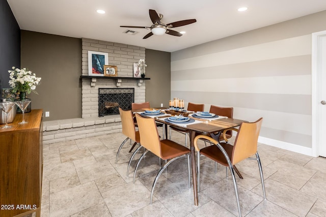 dining room featuring baseboards, a fireplace, visible vents, and recessed lighting