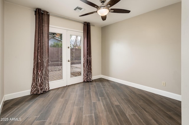 empty room featuring baseboards, visible vents, wood finished floors, and french doors