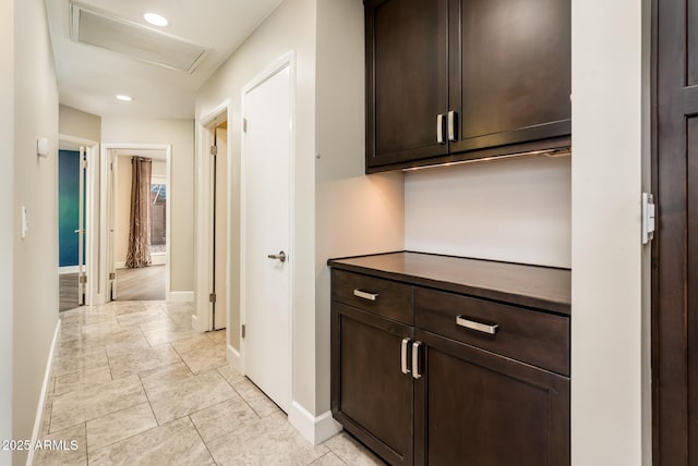 hall with attic access, recessed lighting, visible vents, and baseboards