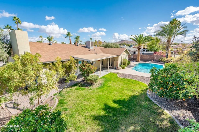 view of pool featuring a patio, cooling unit, fence, a yard, and a fenced in pool