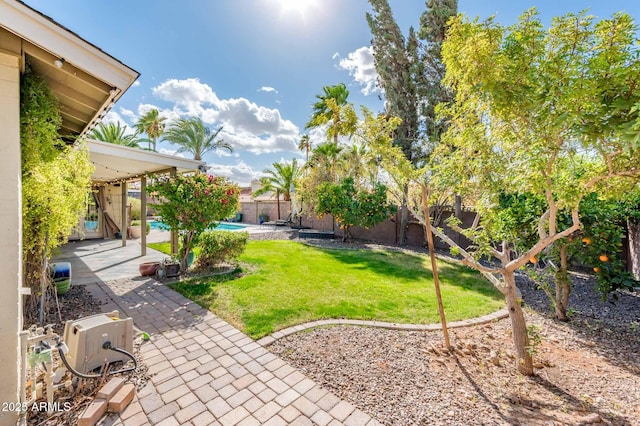 view of yard with a patio area, a fenced backyard, and a fenced in pool