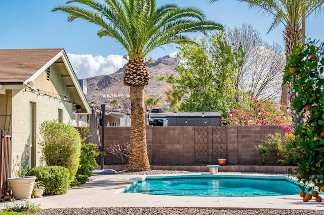 view of pool with fence, a mountain view, and a fenced in pool