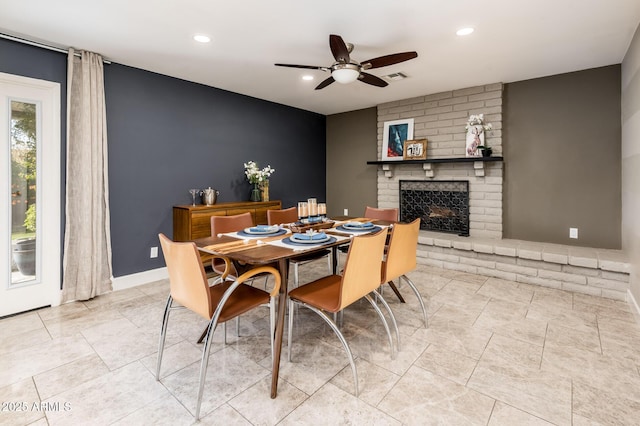 tiled dining space featuring baseboards, visible vents, ceiling fan, a fireplace, and recessed lighting