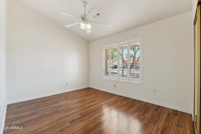 unfurnished room with wood finished floors, visible vents, baseboards, ceiling fan, and vaulted ceiling