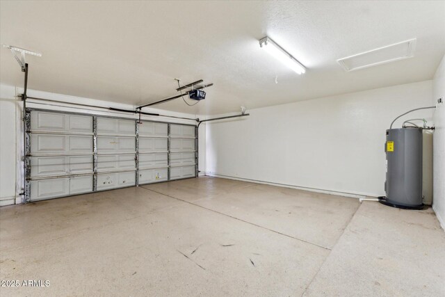 garage featuring electric water heater and a garage door opener