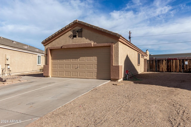 view of side of home with an outdoor structure and a garage