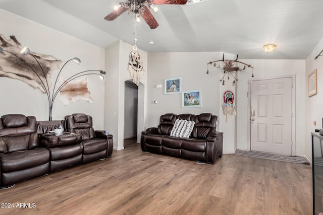 living room with hardwood / wood-style floors, ceiling fan, and lofted ceiling