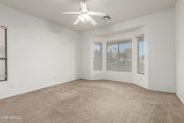 carpeted empty room with ceiling fan