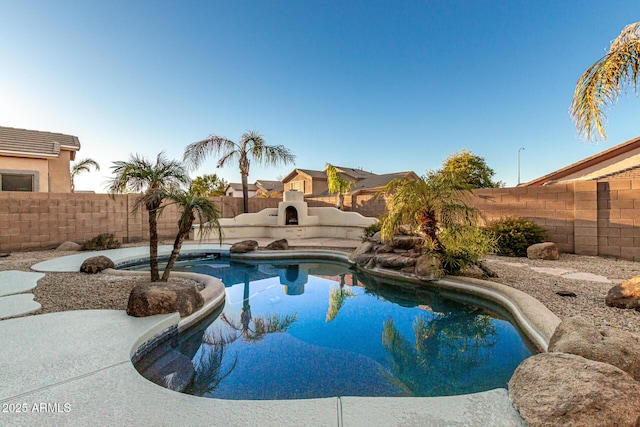 view of swimming pool featuring an outdoor fireplace and a patio area