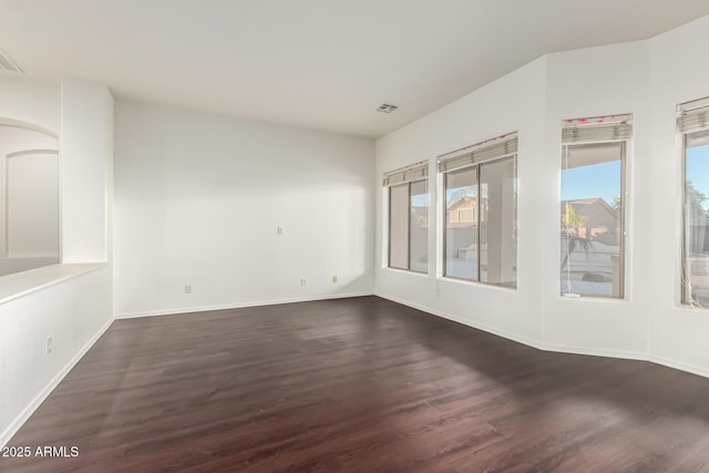 empty room with dark hardwood / wood-style floors