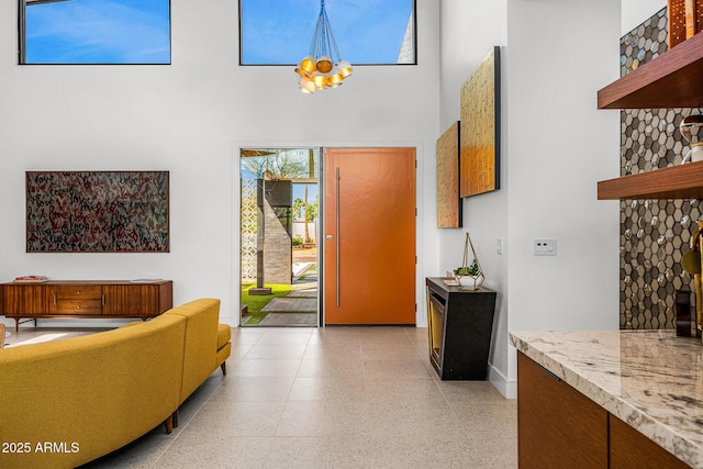 11649 N Miller Rd, Scottsdale, AZ 85260 - entrance foyer with light speckled floor, a towering ceiling, and baseboards