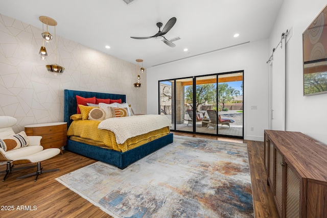 11649 N Miller Rd, Scottsdale, AZ 85260 - bedroom with recessed lighting, access to outside, an accent wall, a barn door, and wood finished floors