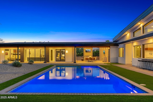 11649 N Miller Rd, Scottsdale, AZ 85260 - pool at dusk featuring french doors, an outdoor pool, and a patio area