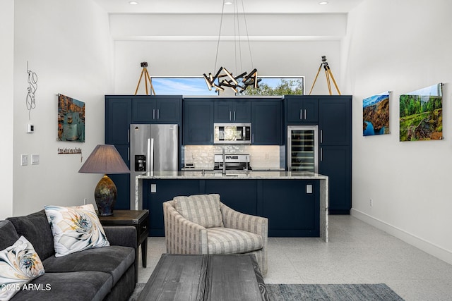 11649 N Miller Rd, Scottsdale, AZ 85260 - living area with baseboards, a towering ceiling, wine cooler, and light speckled floor
