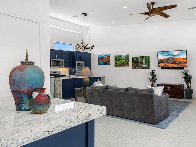 11649 N Miller Rd, Scottsdale, AZ 85260 - living area featuring a high ceiling, ceiling fan with notable chandelier, and recessed lighting
