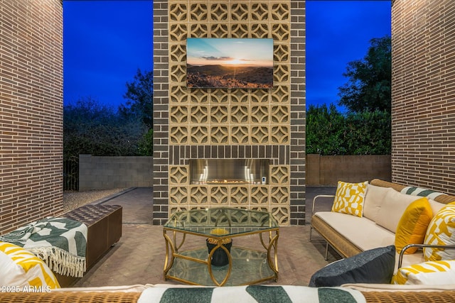 11649 N Miller Rd, Scottsdale, AZ 85260 - patio at night with an outdoor living space with a fireplace and fence