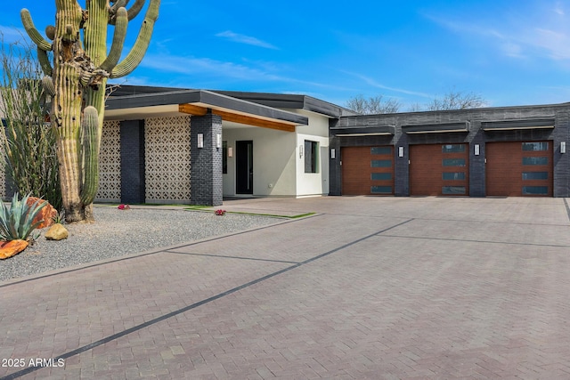 11649 N Miller Rd, Scottsdale, AZ 85260 - modern home with stucco siding, an attached garage, and concrete driveway