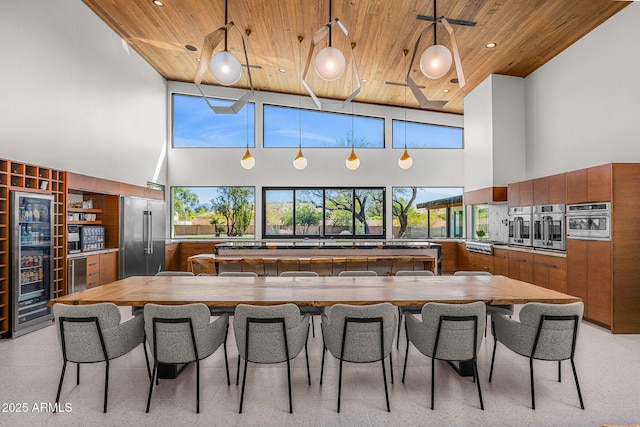 11649 N Miller Rd, Scottsdale, AZ 85260 - kitchen with wood ceiling, modern cabinets, appliances with stainless steel finishes, and brown cabinets