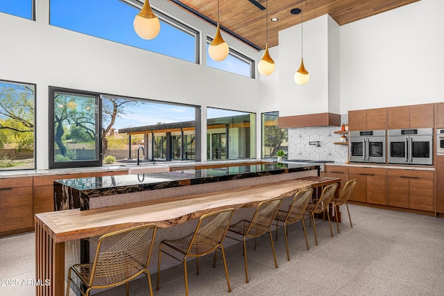11649 N Miller Rd, Scottsdale, AZ 85260 - kitchen featuring wooden ceiling, a high ceiling, light speckled floor, and stainless steel oven
