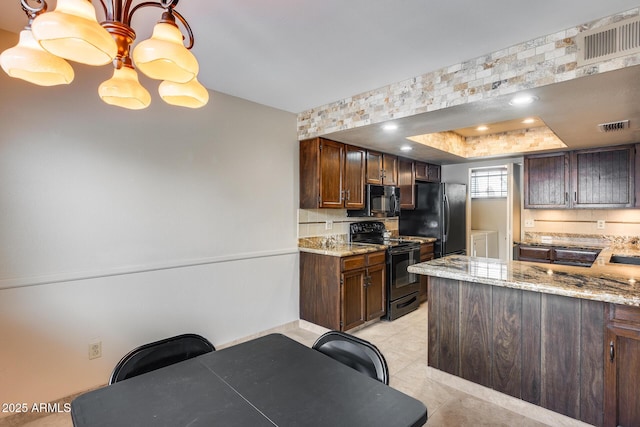 8225 N Central Ave Unit 44, Phoenix, AZ 85020 - kitchen with visible vents, light stone counters, and black appliances
