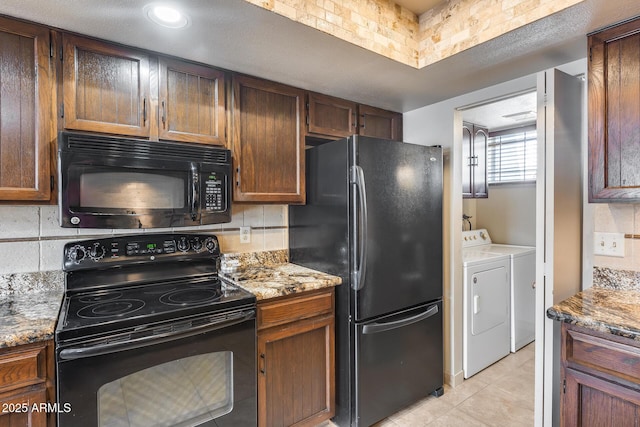 8225 N Central Ave Unit 44, Phoenix, AZ 85020 - kitchen with decorative backsplash, light tile patterned floors, light stone counters, black appliances, and washer and clothes dryer