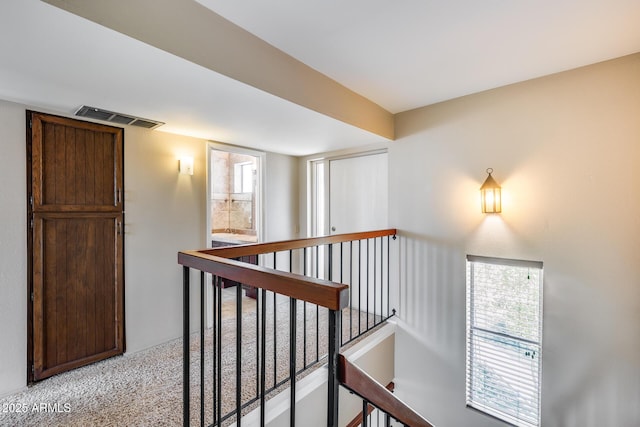 8225 N Central Ave Unit 44, Phoenix, AZ 85020 - corridor with light colored carpet, visible vents, and an upstairs landing