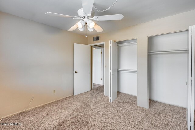 8225 N Central Ave Unit 44, Phoenix, AZ 85020 - unfurnished bedroom with carpet floors, multiple closets, visible vents, and ceiling fan
